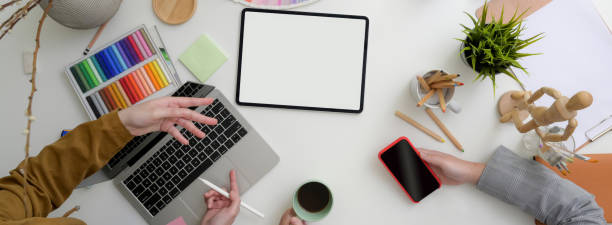 istock Top view of two designers consulting on their project at comfortable workspace 1220474236