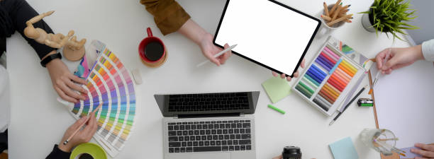 istock Overhead shot of designer team discussing on their project in minimal workspace 1220474261