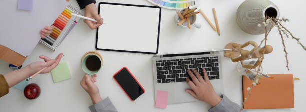 istock Overhead shot of designer team consulting on their project at comfortable workspace 1220474262