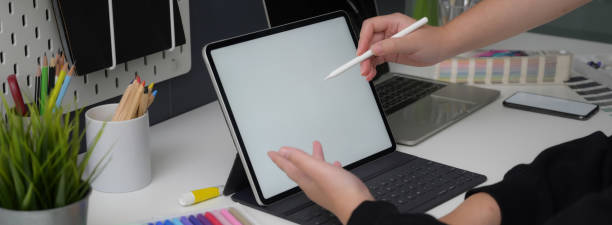 istock Businesswoman working on mock-up tablet  while consulting with her partner 1220475465
