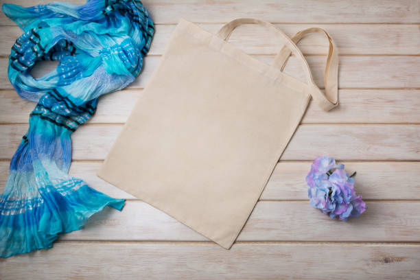 istock Tote bag mockup with blue scarf and flower 1220475578