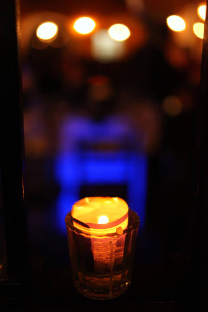 A heart shaped light burns brightly, casting a warm glow in Sweden. The setting is cozy and inviting, perfect for a night filled with friends and conversation.