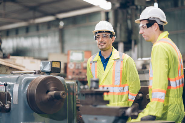 istock two technician inspecting discussion to metal component at machine in factory 1220482518