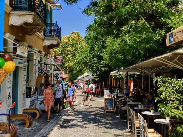 A beautiful sunny summer day with tourists exploring the interesting shops and restaurants along the streets of downtown Athens, Greece stock photo