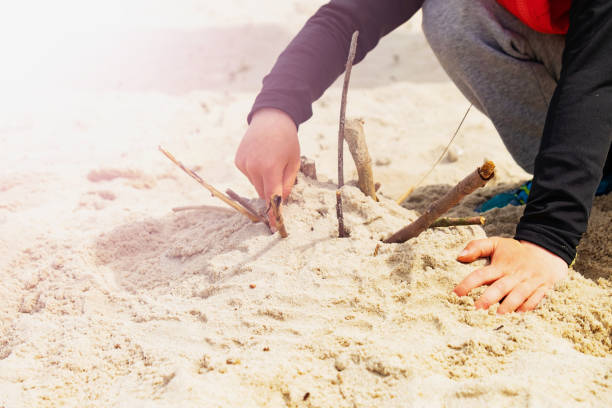 istock Boys hands playing in the sand at the beach. 1220485501