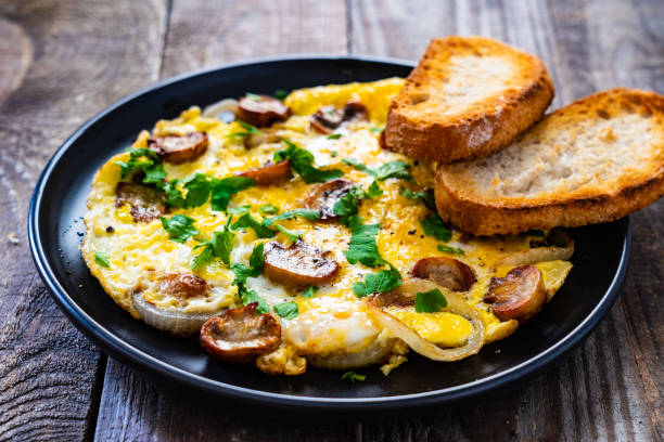 istock Omelette with mushrooms on wooden board 1220485577