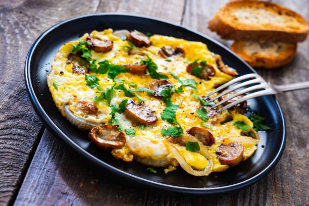 istock Omelette with mushrooms on wooden board 1220485625