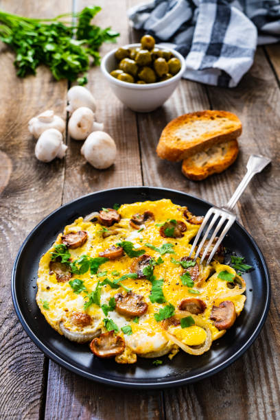 istock Omelette with mushrooms on wooden board 1220485678