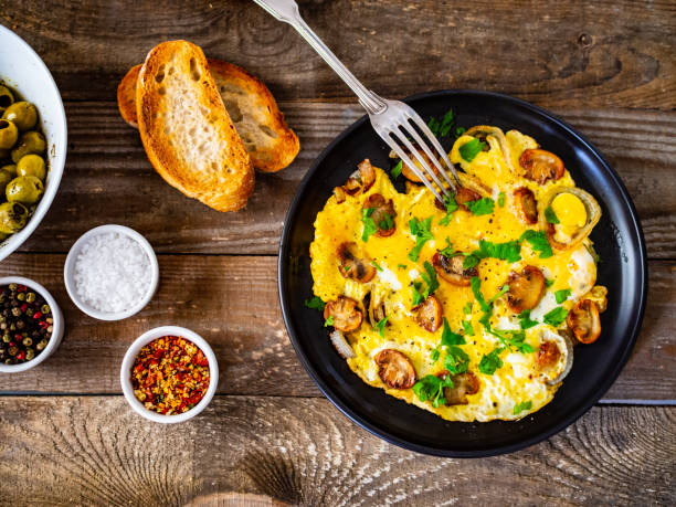 istock Omelette with mushrooms on wooden board 1220485704