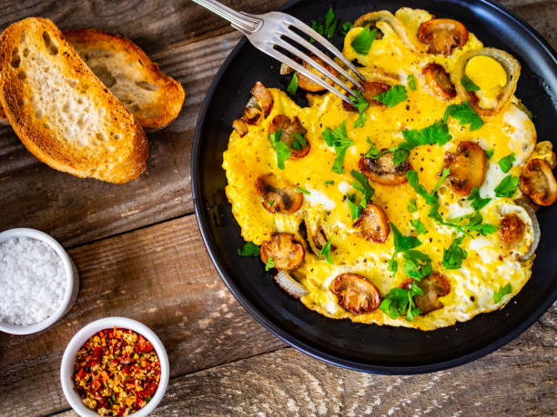 istock Omelette with mushrooms on wooden board 1220485727