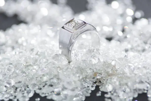 Photo of Close up of diamond ring on jewelry background, platinum ring on diamond.