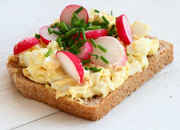 istock Egg salad over whole grain toast with radish and chives. 1220487017
