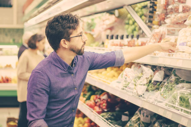 istock Young man shopping in grocery store 1220491237