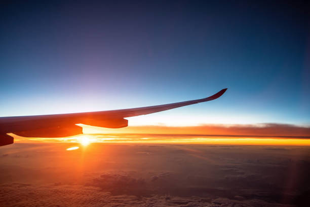 istock Airplane wing above beautiful sunrise sky (view from airplane) 1220492262