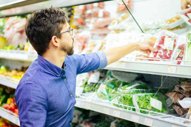 istock Focused young man shopping in grocery store 1220492683
