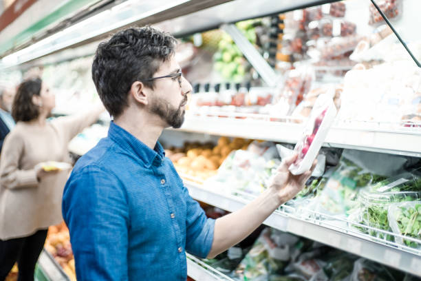 istock Man looking at vegetables in grocery store 1220494834