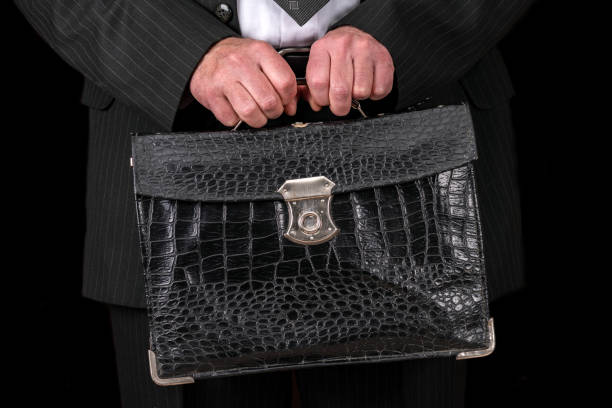 istock Vintage leather briefcase in a businessman hand 1220497429