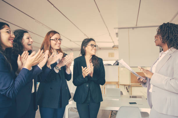 istock Side view of cheerful coworkers applauding after presentation 1220498525