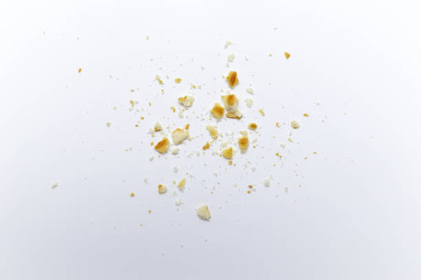 istock Scattered crumbs of cookies on white background. 1220498547