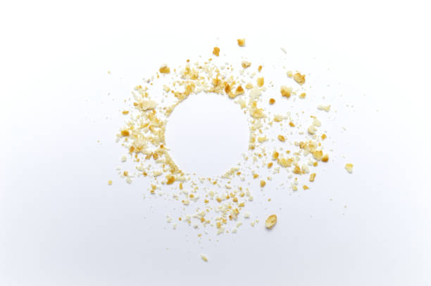 Scattered crumbs of cookies on white background. Copy space.