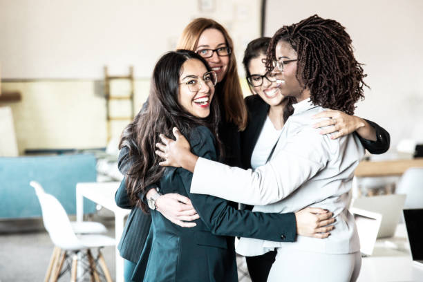 istock Successful female business team hugging in office 1220499279