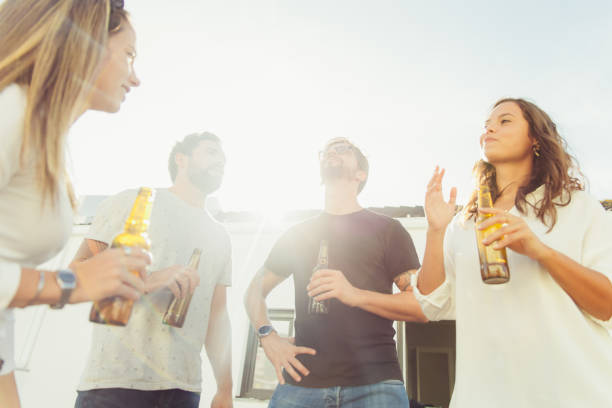 istock Cheerful young people hanging out with beer 1220500617