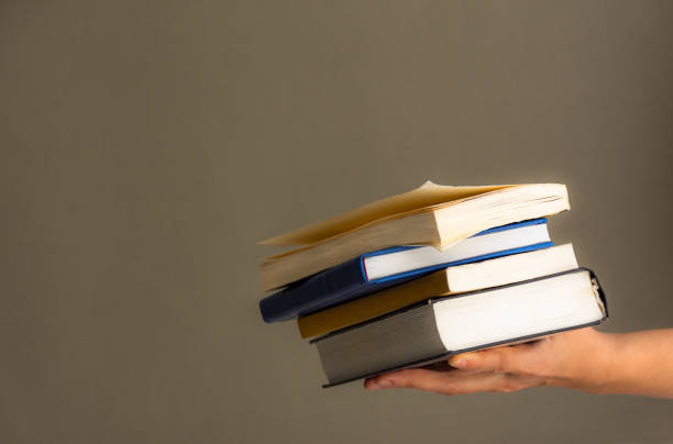 istock A stack of books in your hand 1220501506