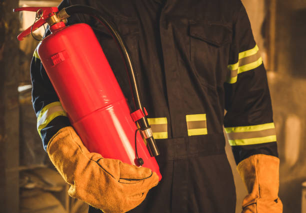 istock Close up hand Fireman,Firefighter holding the fire extinguisher. 1220502542