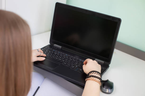istock A teenager sits and writes while doing homework. 1220504222