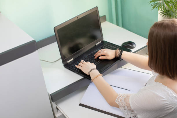 istock A teenager sits and writes while doing homework. 1220504248
