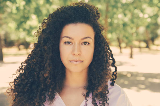 istock Beautiful curly woman standing and looking at camera 1220504449