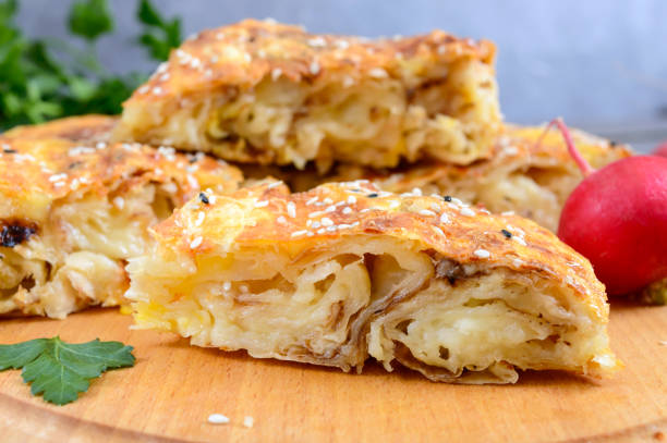 istock Burek Turkish pie. Lavash puff pie with cheese and sesame seeds 1220505407