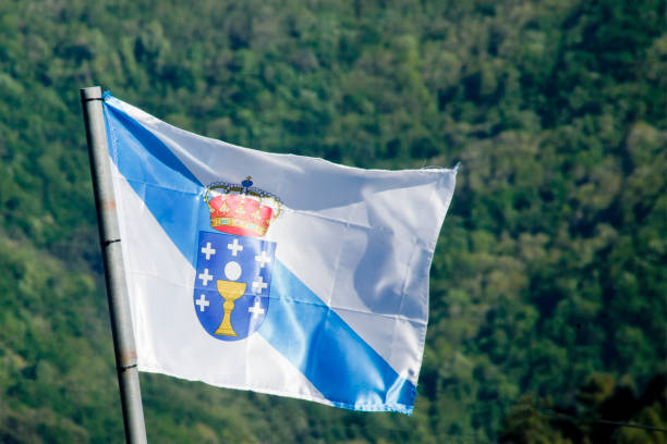 istock Galicia flag fluttering in the wind, beautiful forest background. 1220506827