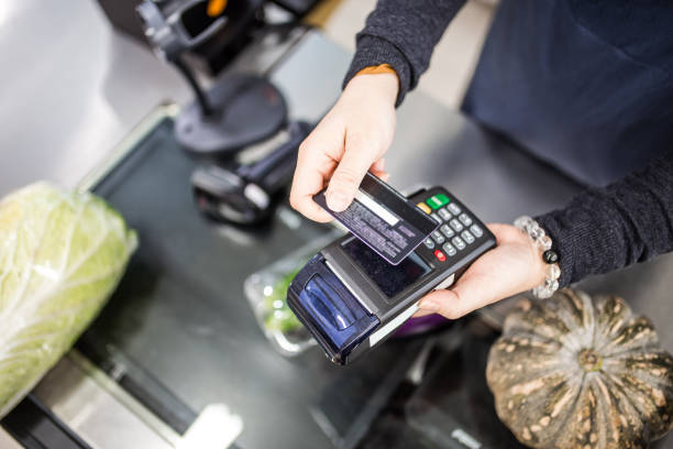istock A cashier using wireless terminal checkout in supermarket. 1220509616