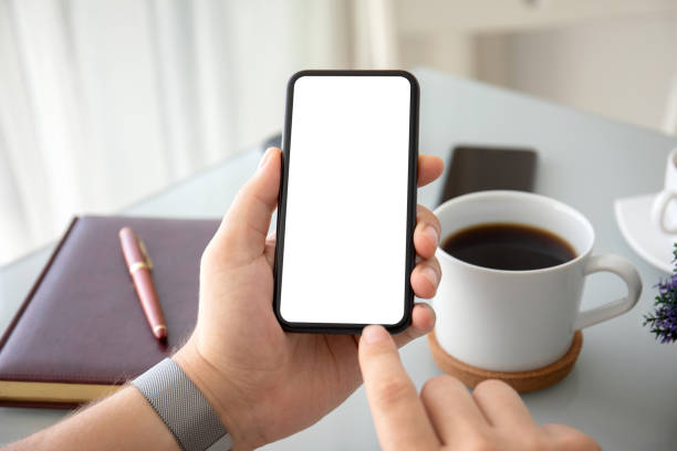 istock male hands holding phone with isolated screen in the office 1220512498