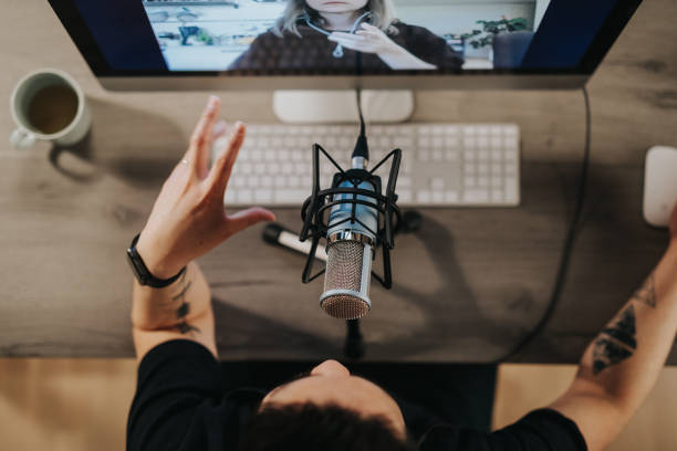 istock High angel view of a podcaster gesturing behind microphone 1220513169