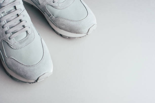 Gray sneakers on a gray background.