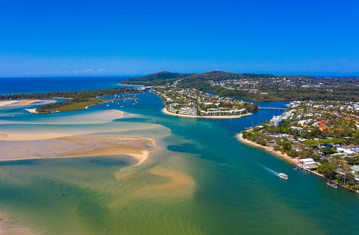 An aerial view of Noosaville and a different building structure along with an over looking view of the National Park Hill in Queensland, Australia