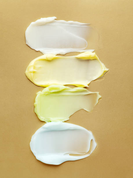istock Different colour cream smears on gold background. 1220513867
