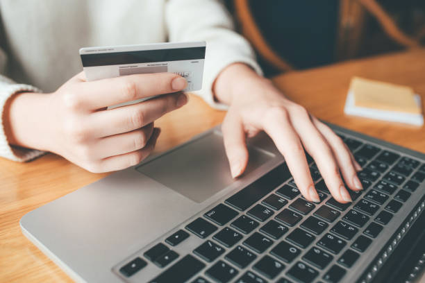 istock A young woman makes an online payment for a purchase. 1220514097