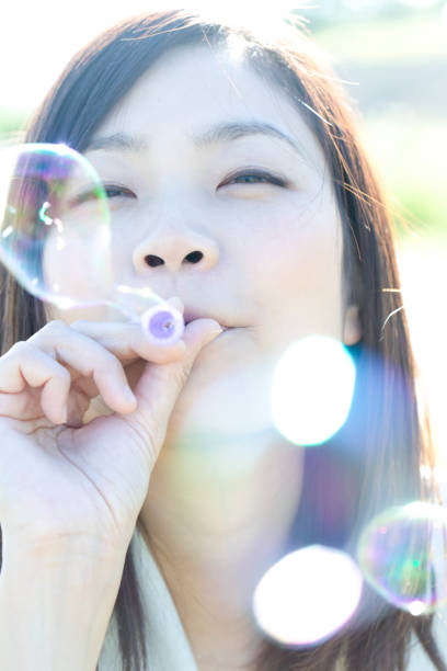 istock A young Japanese woman is blowing bubbles. 1220514831
