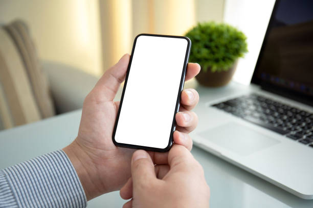 istock male hands holding phone with an isolated screen in office 1220515198