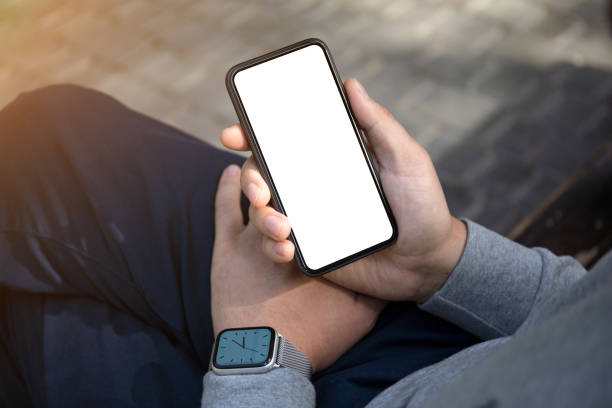 istock male hands with watch holding phone isolated screen in park 1220515501