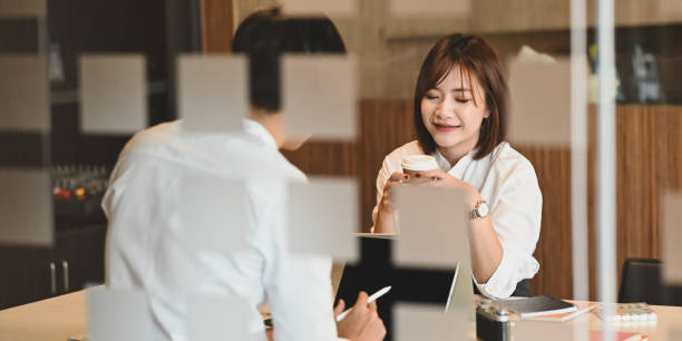istock Photo of young couple working with computer laptop and computer tablet while sitting together at the working table over modern and comfortable living room as background. 1220516760