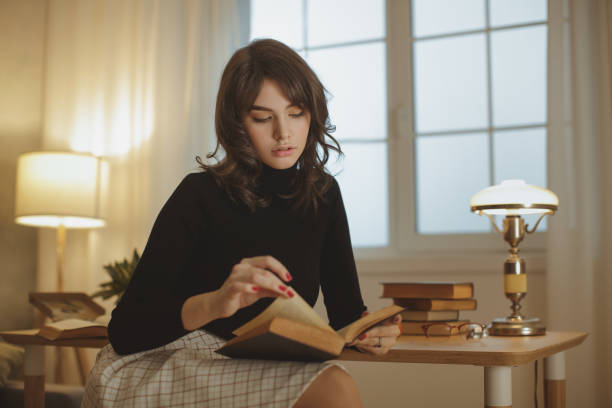 istock Woman Reading Book at Home 1220516903