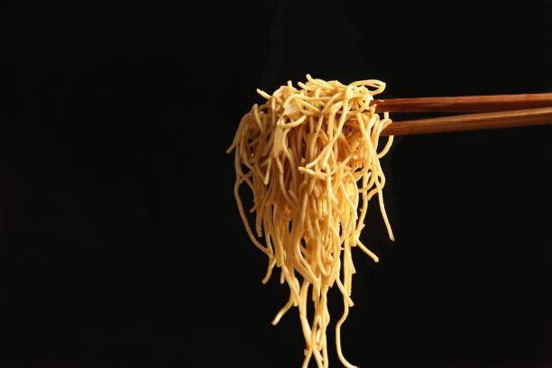 istock Wooden chopsticks picking noodle.photo 1220517316
