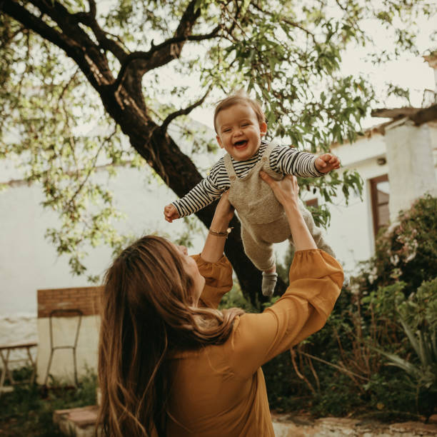 istock Woman holding her baby while smiles. 1220517454