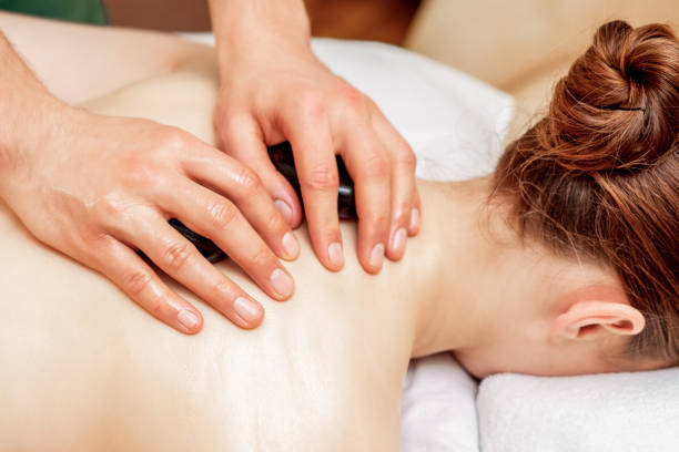 istock Stone massage on back of woman. 1220519819