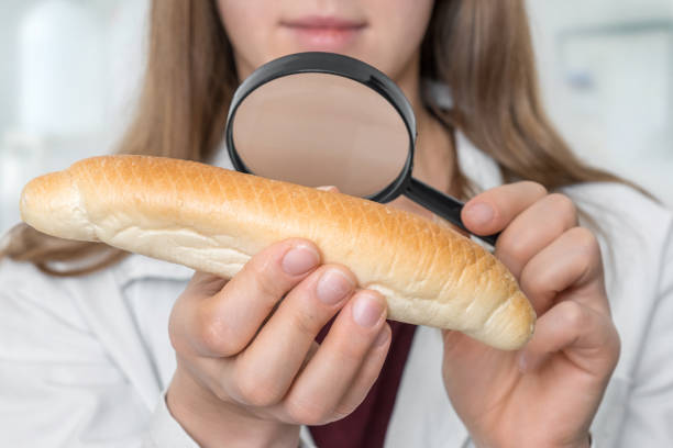 istock Scientist examines a croissant with magnifying glass 1220521307