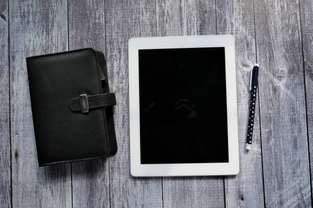 top view of digital tablet and tea on wooden table .